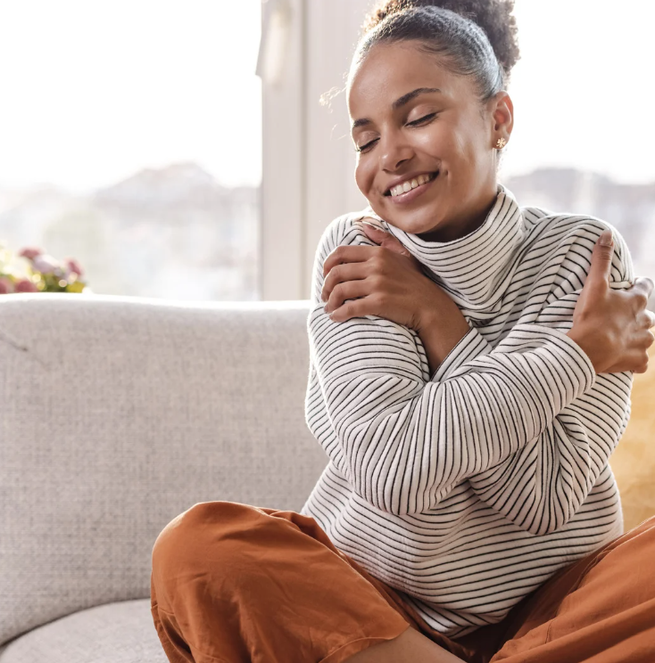 woman hugging herself for self-love practice