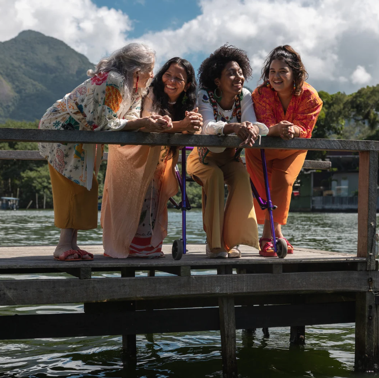 group of 4 middle age women standing by the lake