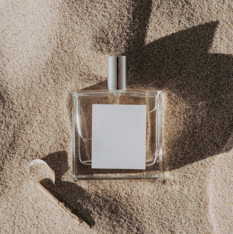 fragrance bottle in the sand