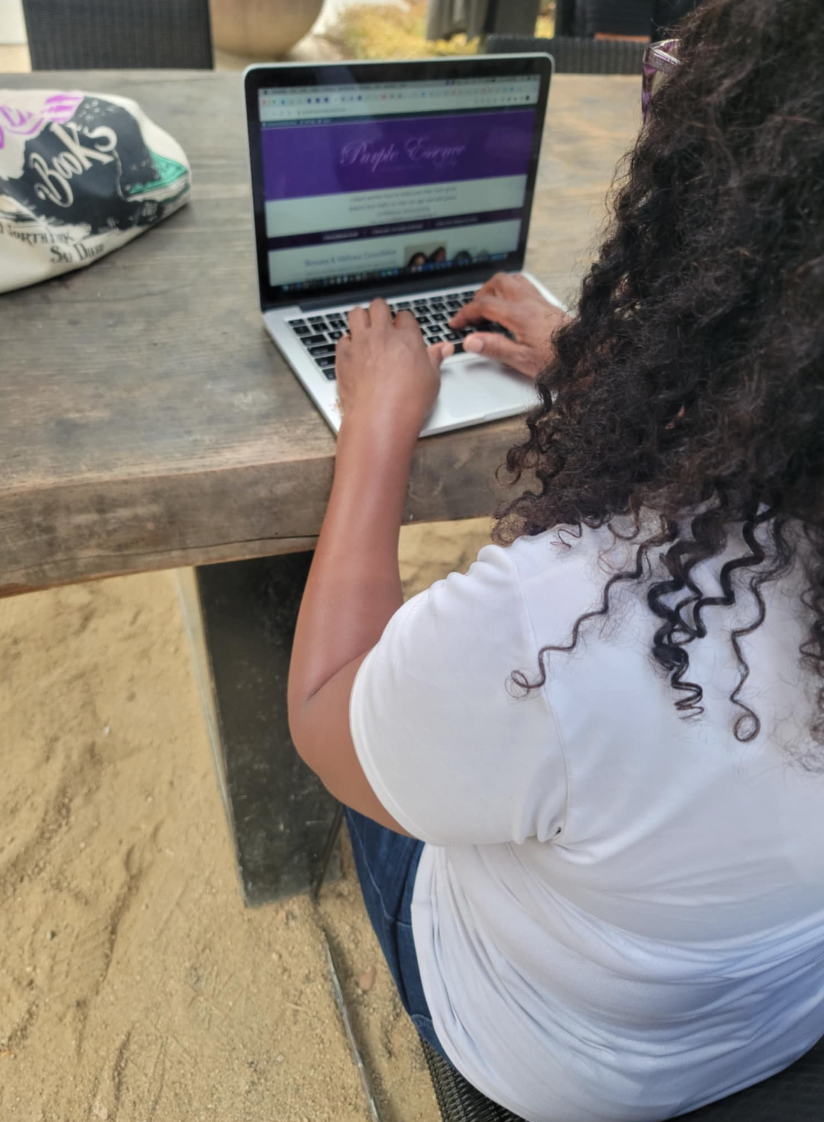 Evelyn from Purple Essence by Evelyn working on her laptop, showing the flexibility and freedom of being a JAFRA consultant.