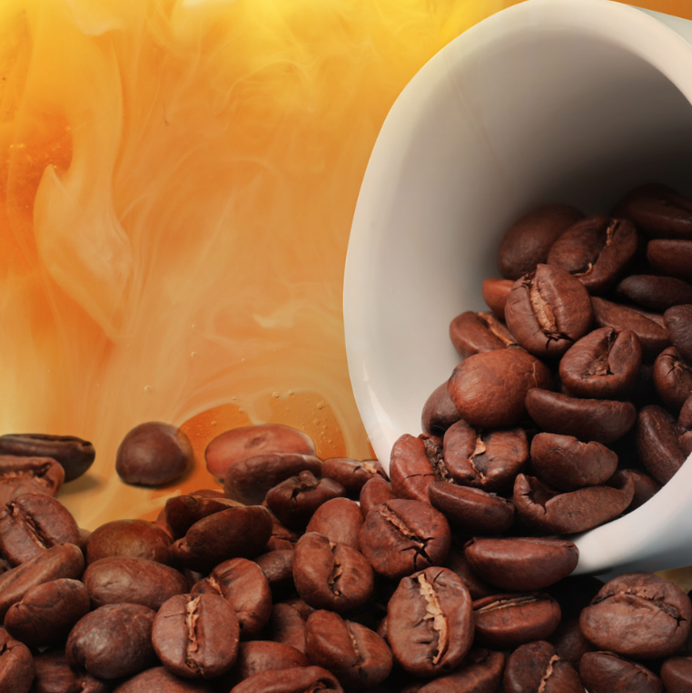 Coffee beans spilling from a white cup with creamy coffee background, representing caffeine in skincare and its benefits for puffiness and dark circles