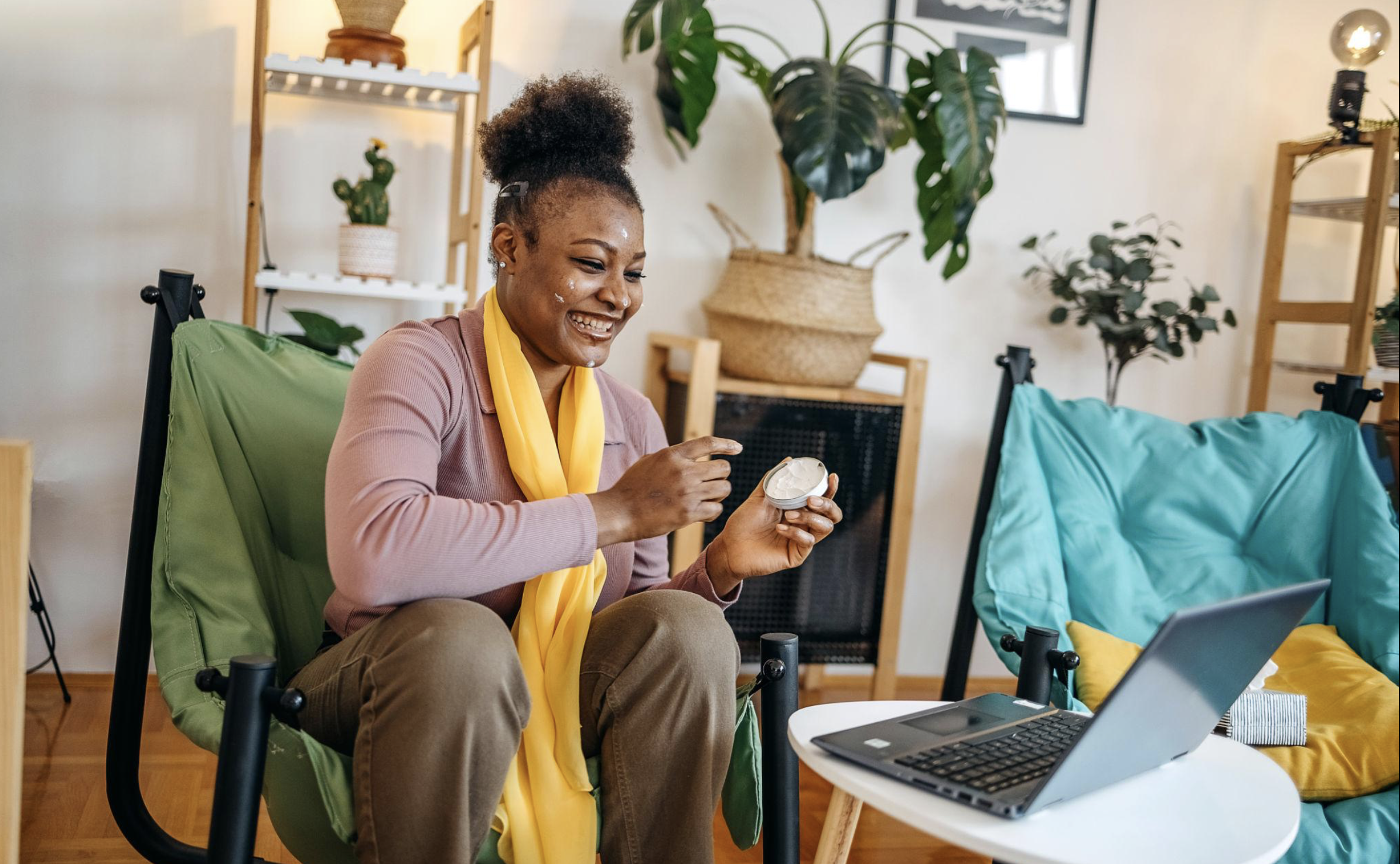 Woman applying skincare while working from home, representing the flexibility, savings, and business opportunities available through the JAFRA compensation plan.