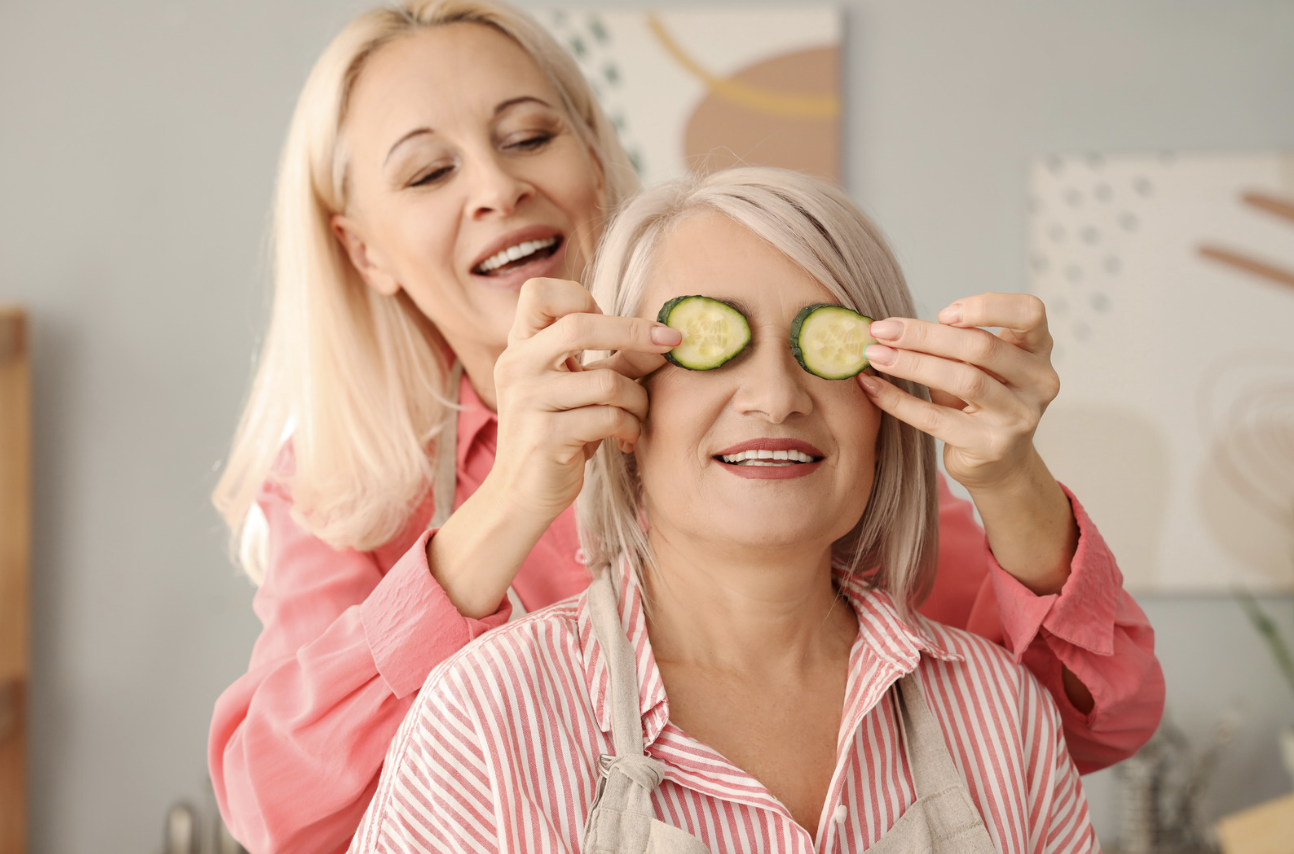 Woman over 40 using cucumber slices as a natural remedy for dark circles and puffy eyes
