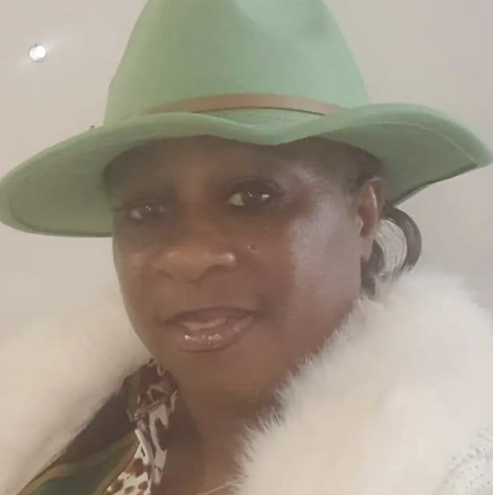 Woman wearing green hat and fur coat