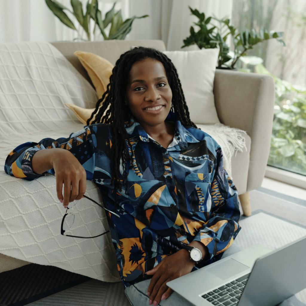 Woman relaxing at home with a laptop while exploring age well resources
