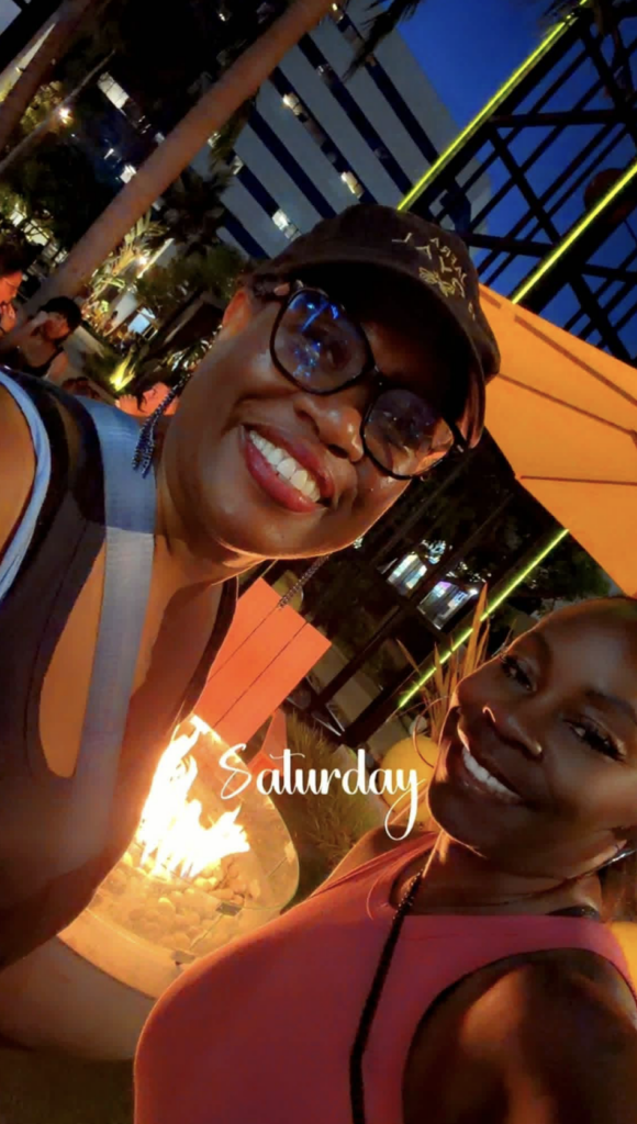 Evelyn Abernathy enjoying time with a friend by the fire pit at The Enclave
